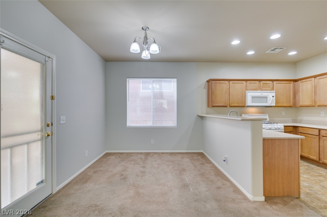 8937 Caledon Ridge Court Las Vegas, NV 89149 - Photo 13 of 43 A streamlined kitchen layout provides convenient dining area access.