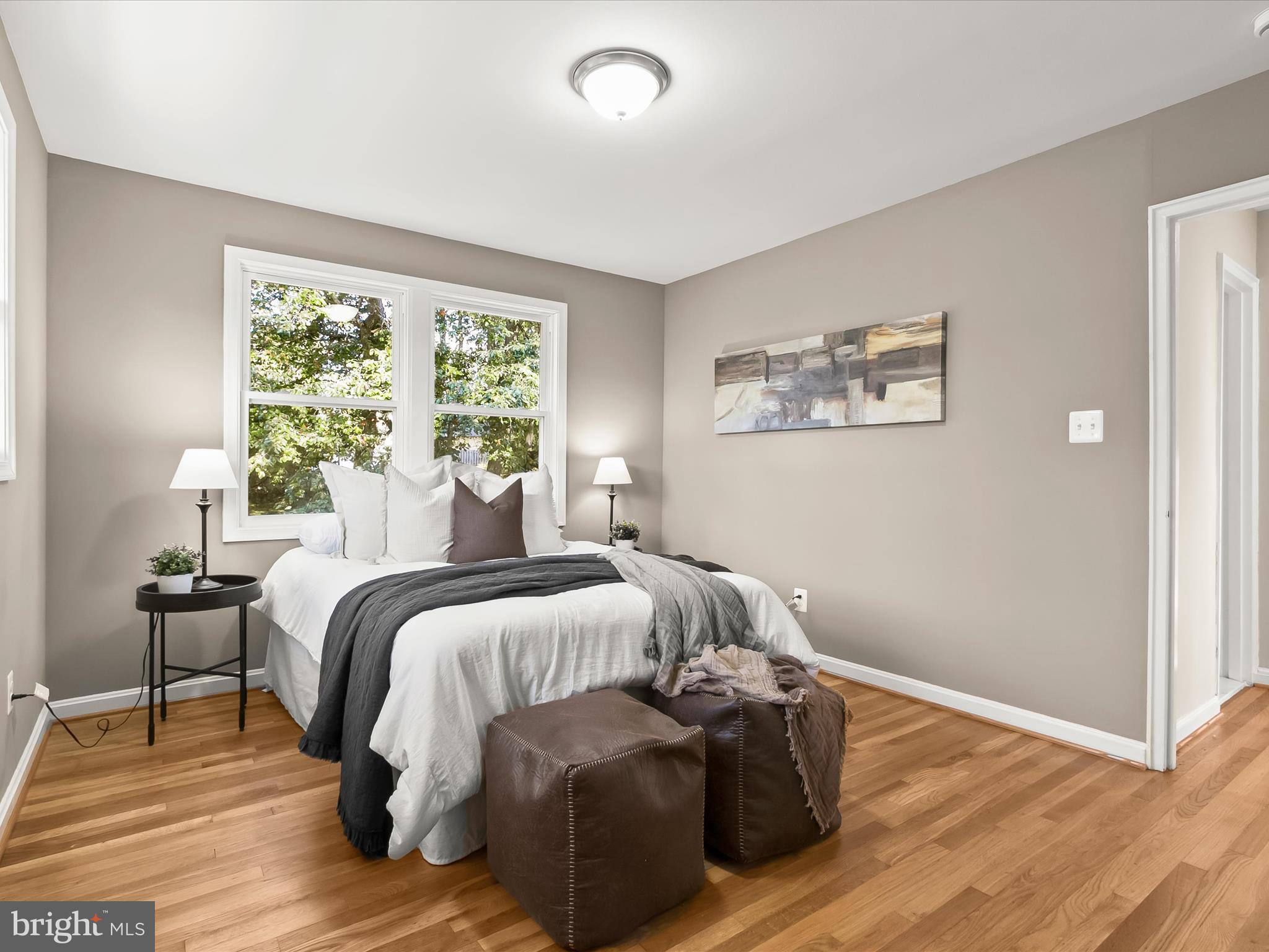 13211 Holdridge Road Silver Spring, MD 20906 - Photo 13 of 32 a bedroom with a bed and wooden floor