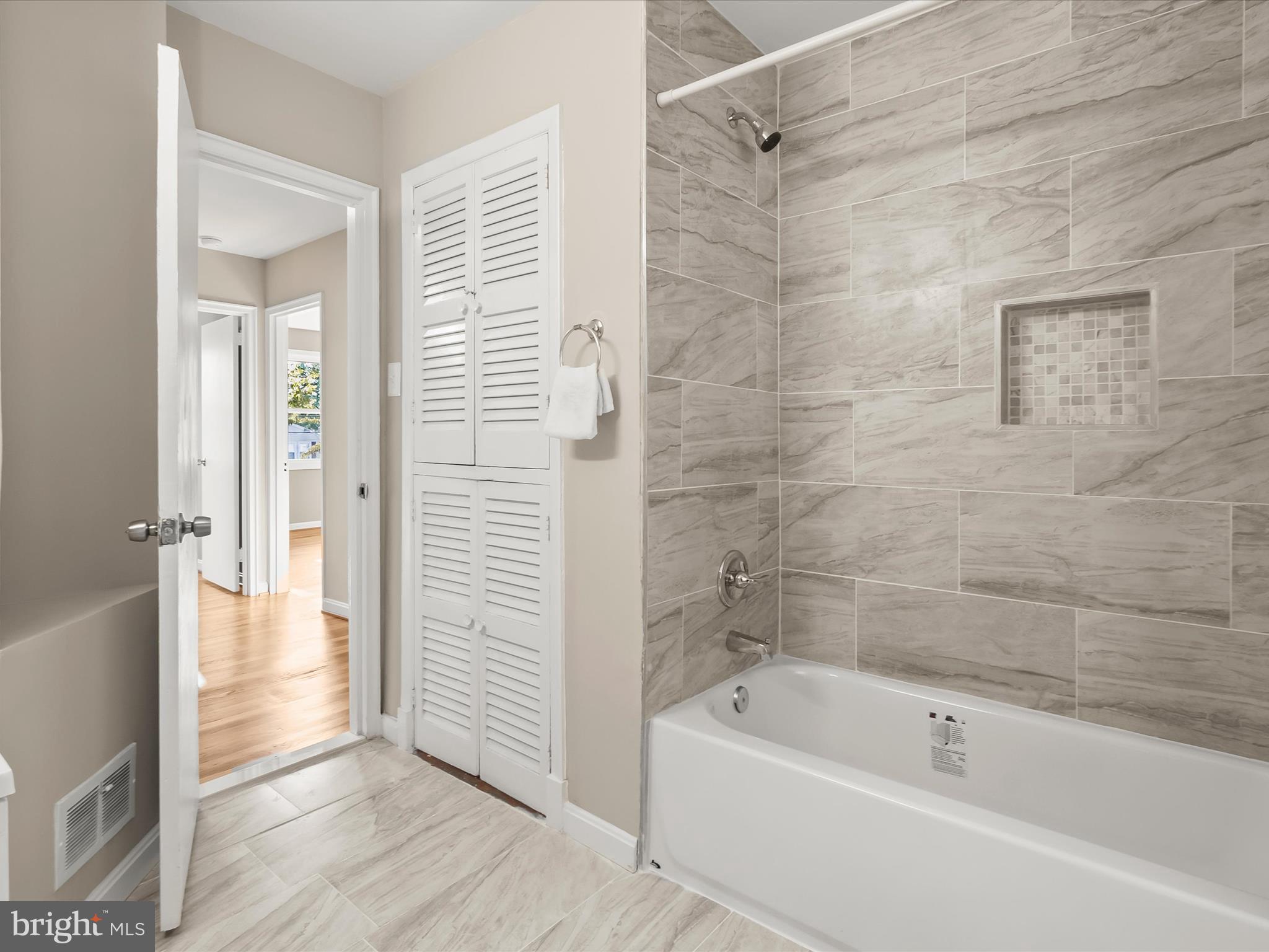 13211 Holdridge Road Silver Spring, MD 20906 - Photo 16 of 32 a bathroom with a bathtub and a shower