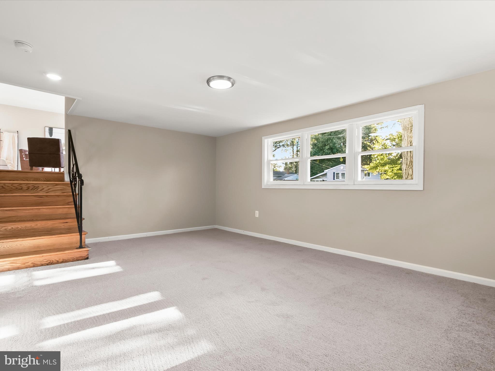 13211 Holdridge Road Silver Spring, MD 20906 - Photo 22 of 32 a view of an empty room with wooden floor and a window