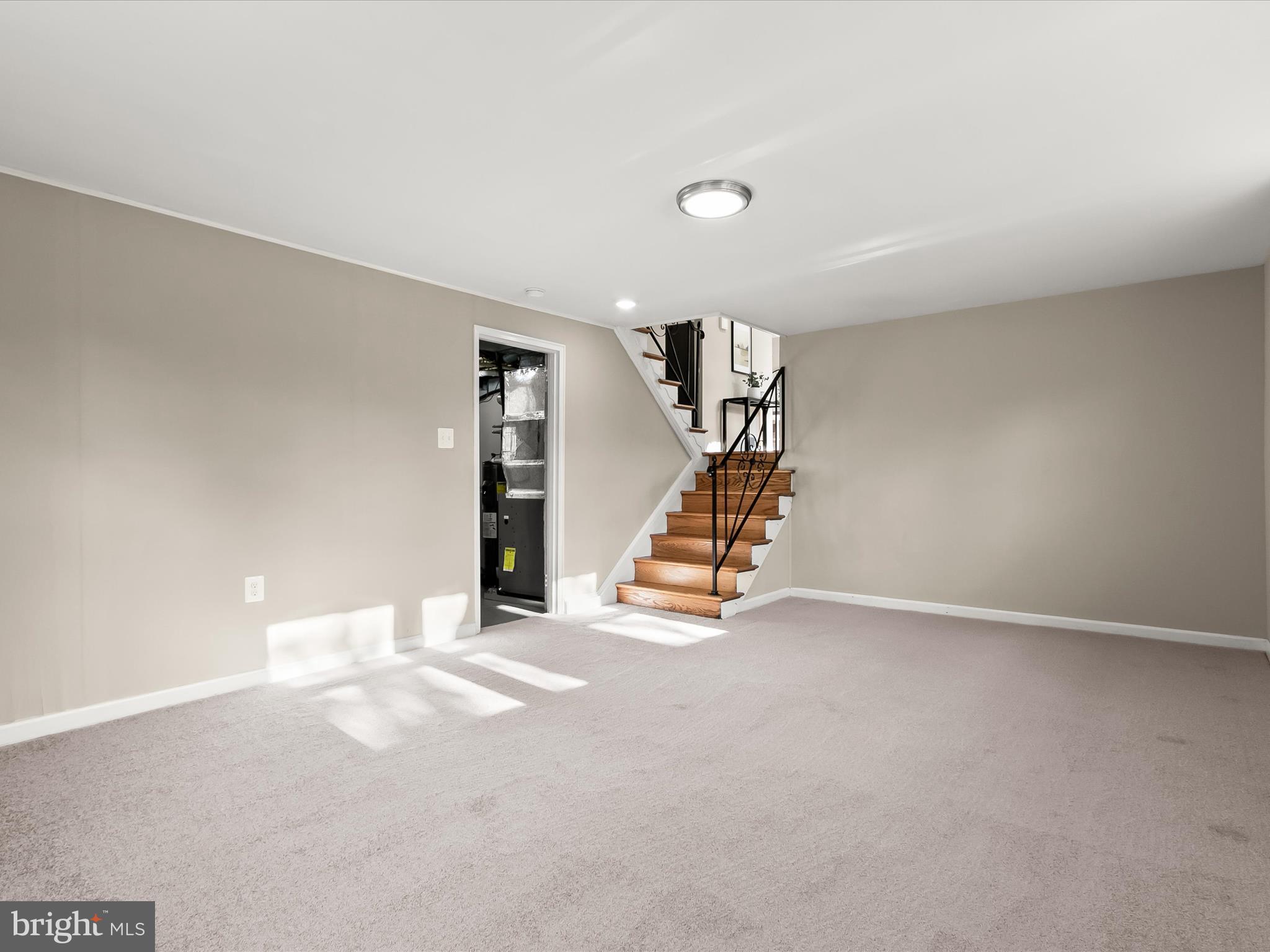 13211 Holdridge Road Silver Spring, MD 20906 - Photo 23 of 32 an empty room with stairs and windows