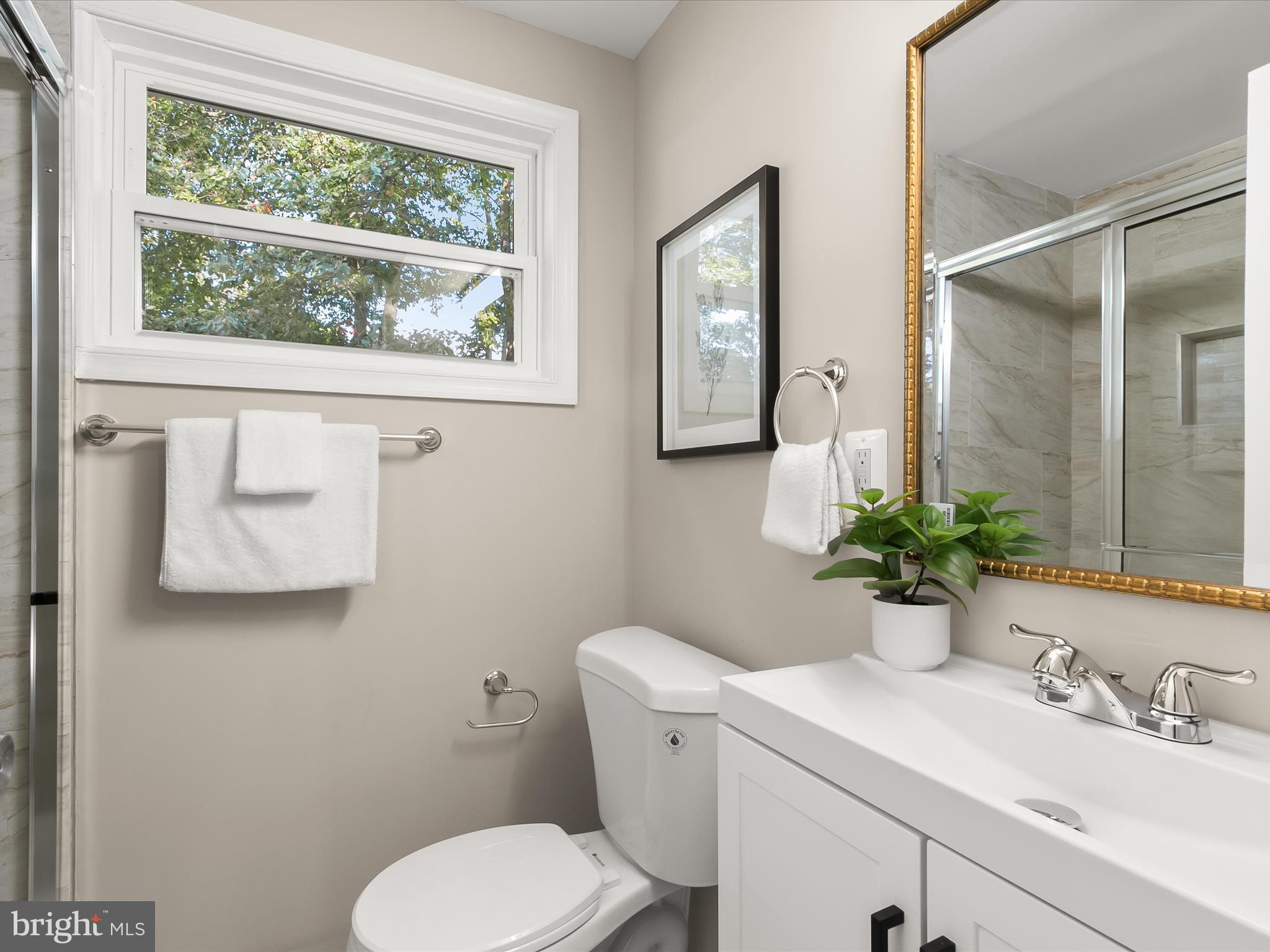 13211 Holdridge Road Silver Spring, MD 20906 - Photo 24 of 32 a bathroom with a toilet sink and mirror