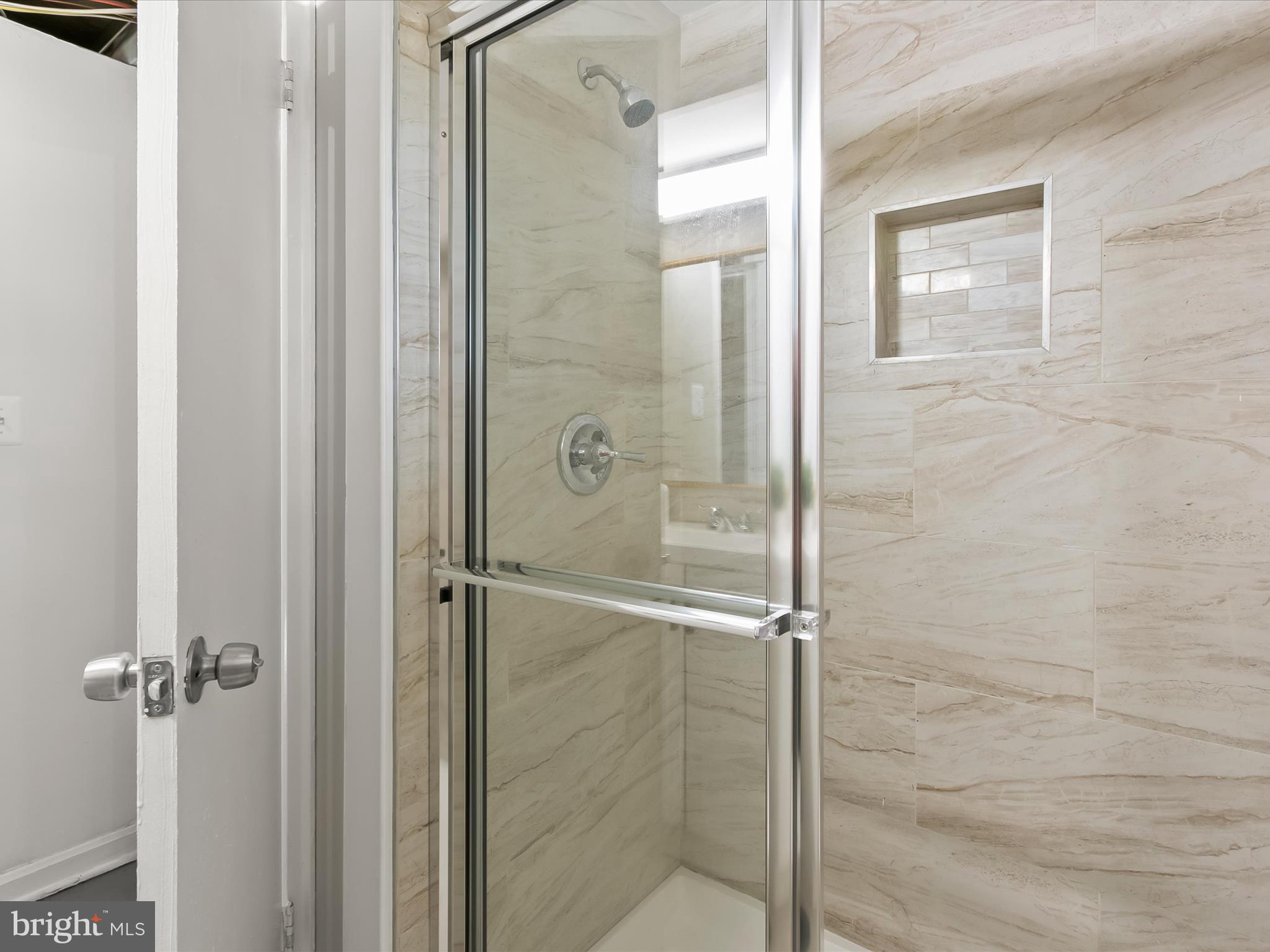 13211 Holdridge Road Silver Spring, MD 20906 - Photo 25 of 32 a bathroom with a glass shower door