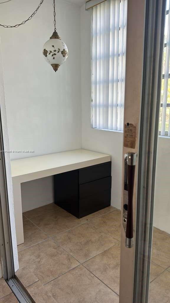 219 Northeast 14th Avenue, Unit 103 Hallandale Beach, FL 33009 - Photo 11 of 11 a room with windows and a chandelier