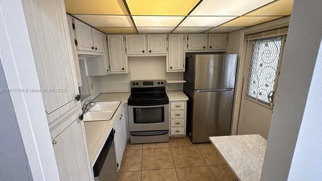 a kitchen with a refrigerator and a stove