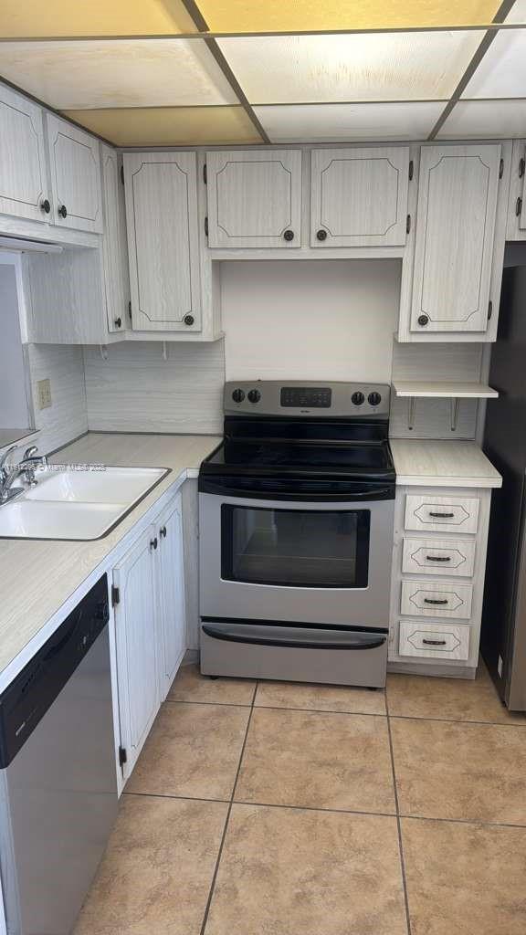 219 Northeast 14th Avenue, Unit 103 Hallandale Beach, FL 33009 - Photo 4 of 11 a kitchen with a stove and a sink