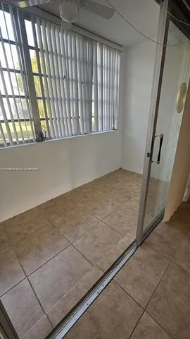 a view of an empty room and staircase