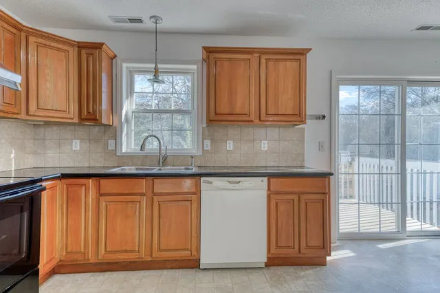 a kitchen with stainless steel appliances granite countertop a sink and cabinets