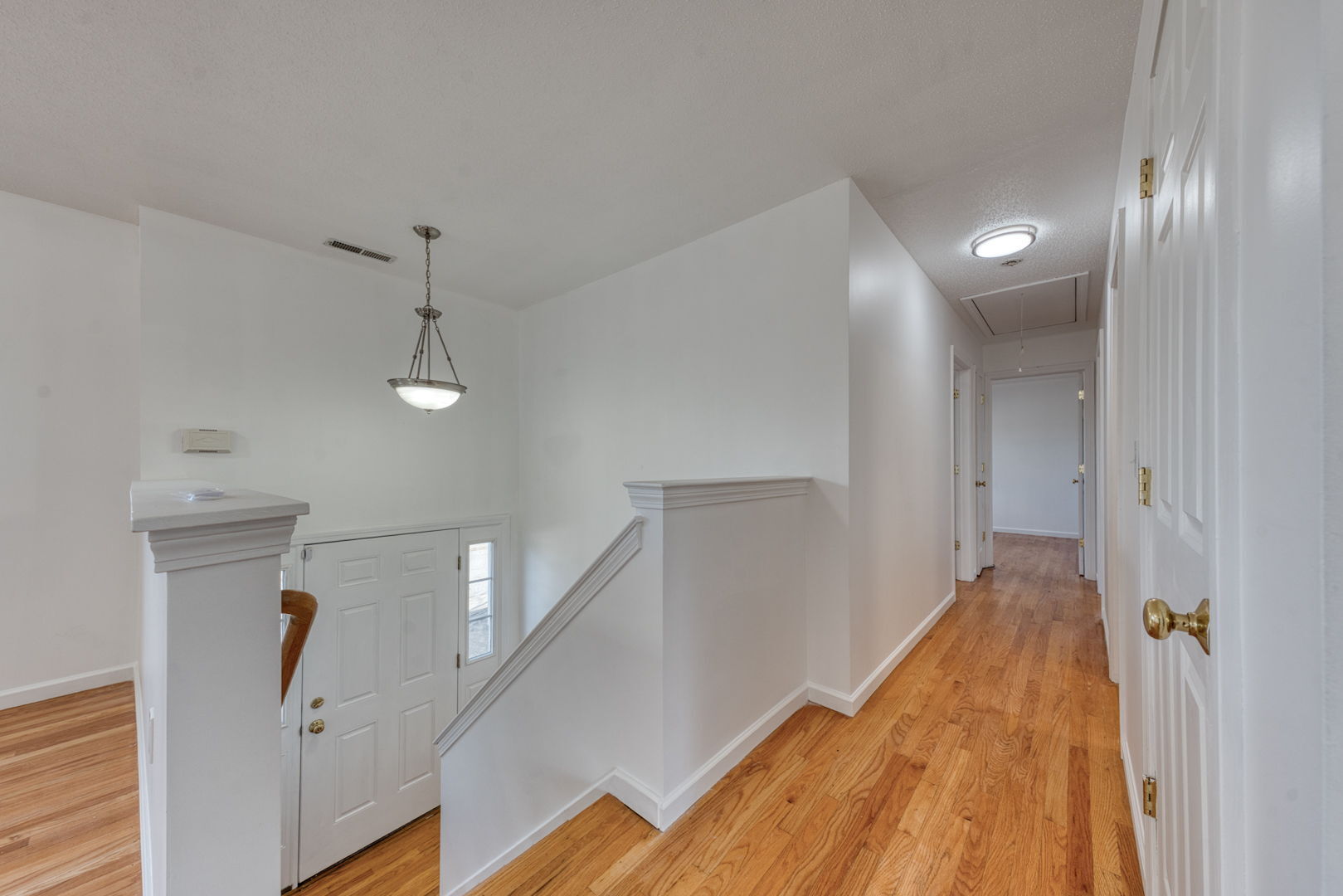 27 Aspen Place Windham, CT 06226 - Photo 17 of 39 a view of hallway with stairs and wooden floor