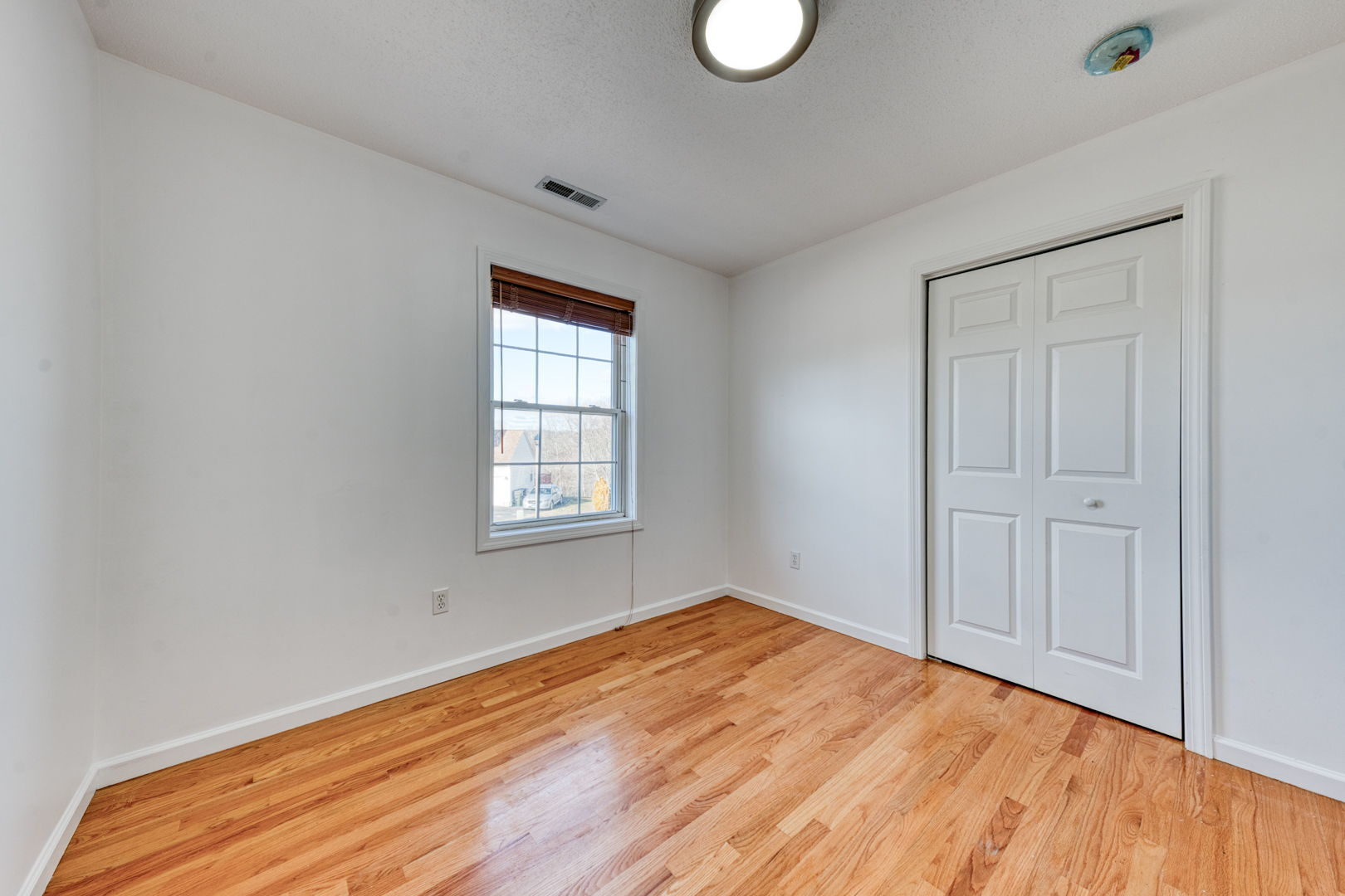 27 Aspen Place Windham, CT 06226 - Photo 24 of 39 a view of empty room with wooden floor and fan