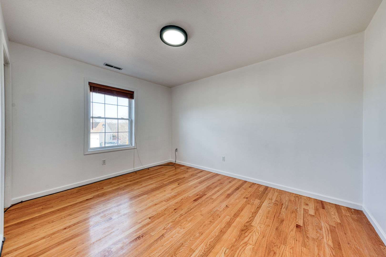 27 Aspen Place Windham, CT 06226 - Photo 25 of 39 an empty room with wooden floor and windows