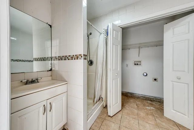 a bathroom with a shower sink and mirror