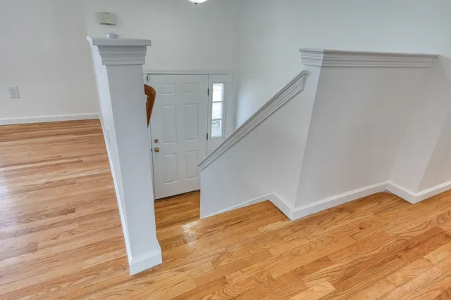 a view of entryway and hall with wooden floor