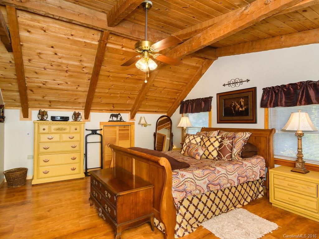 27 High Ridge Road Leicester, NC 28748 - Photo 12 of 24 a bed room with a bed and a chair