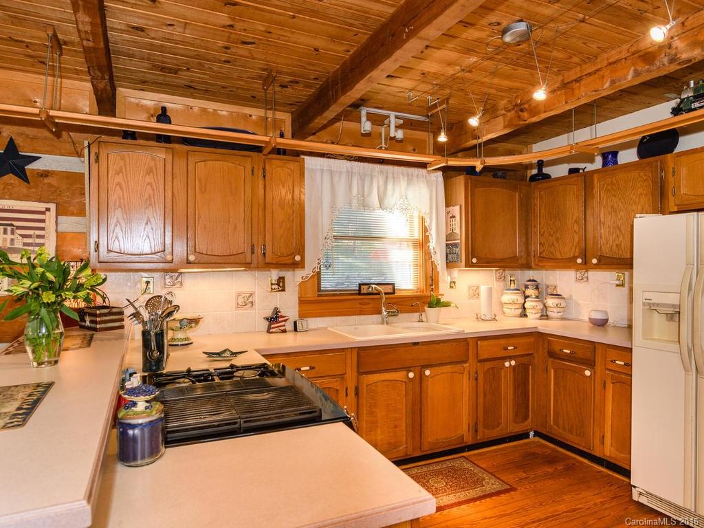 27 High Ridge Road Leicester, NC 28748 - Photo 9 of 24 a kitchen with a sink a stove and cabinets