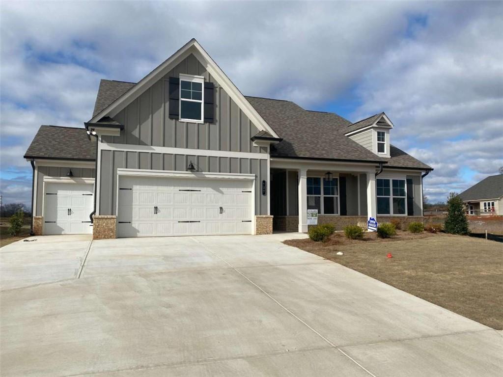 129 Oakdale Road Jefferson, GA 30549 - Photo 1 of 1 a front view of a house with a yard and garage