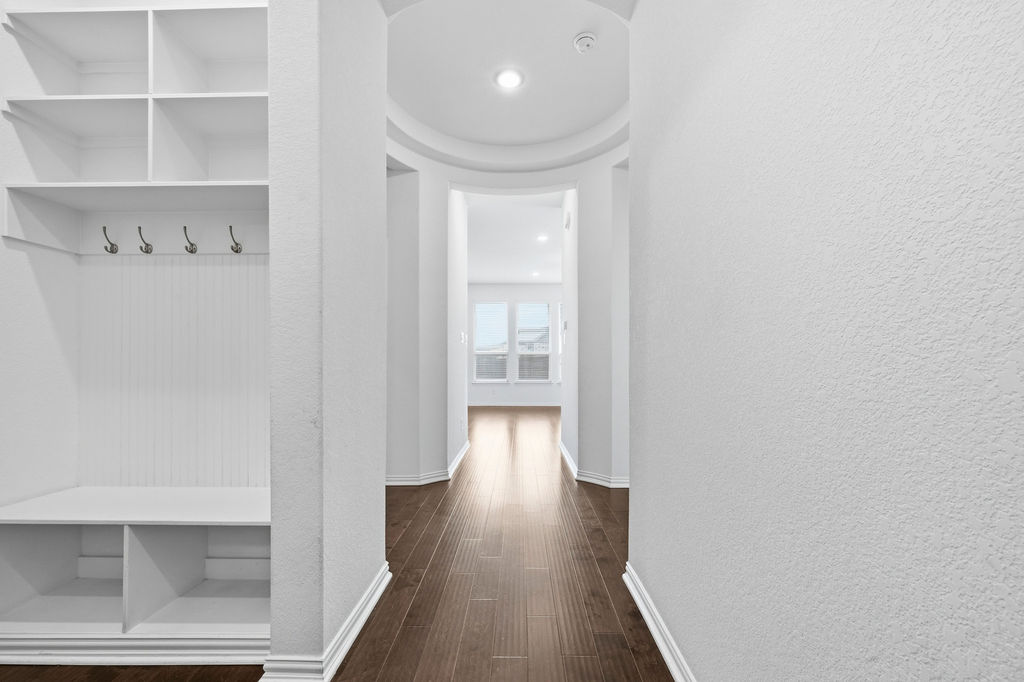 1005 Ridge Runner Drive Georgetown, TX 78628 - Photo 10 of 32 Entryway mudroom featuring built-in shelving, coat hooks, and bench seating