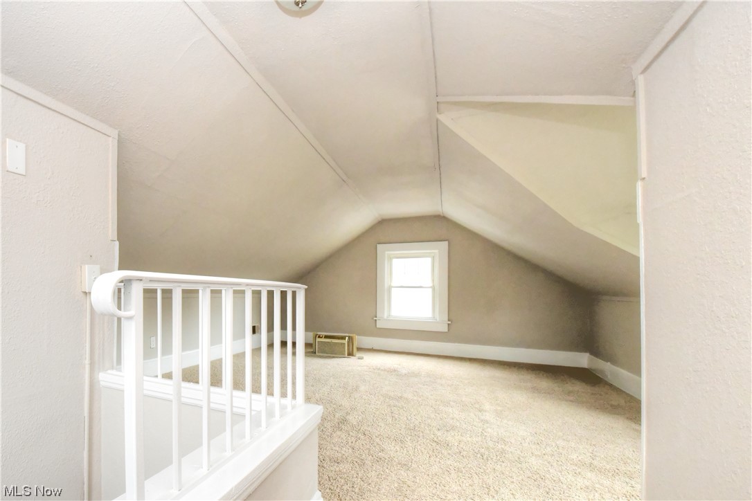 3347 Cedarbrook Road Cleveland, OH 44118 - Photo 19 of 22 Additional living space with a textured ceiling, light carpet, and lofted ceiling