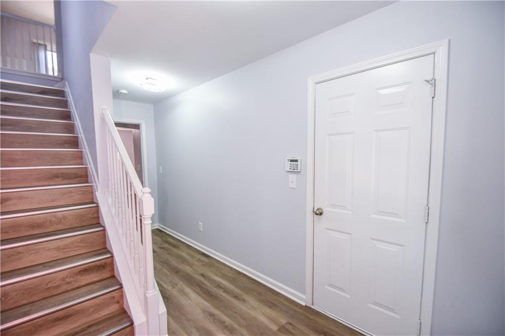 2201 Landing Walk Drive Duluth, GA 30097 - Photo 16 of 80 a view of a hallway with wooden floor and entryway