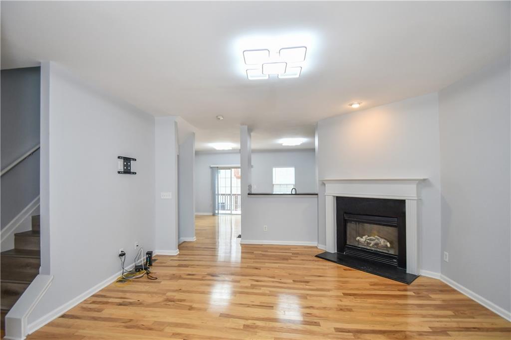2201 Landing Walk Drive Duluth, GA 30097 - Photo 21 of 80 a view of empty room with wooden floor and fireplace