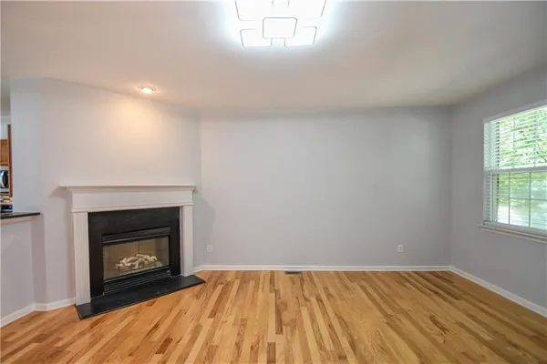 a kitchen with stainless steel appliances granite countertop a refrigerator stove a sink and dishwasher with wooden floor
