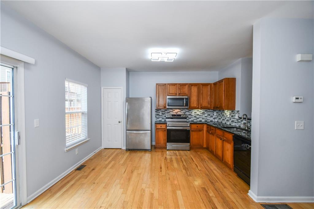 2201 Landing Walk Drive Duluth, GA 30097 - Photo 33 of 80 a kitchen with stainless steel appliances granite countertop a sink stove and refrigerator