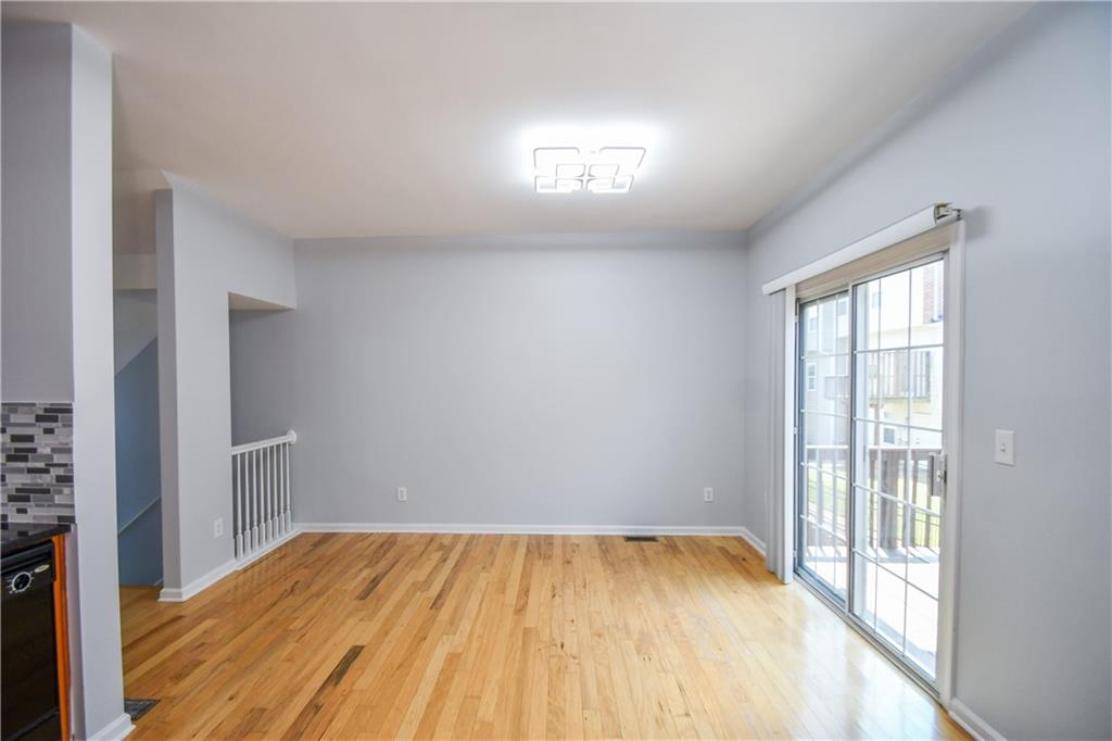 2201 Landing Walk Drive Duluth, GA 30097 - Photo 37 of 80 a view of empty room with wooden floor and fan