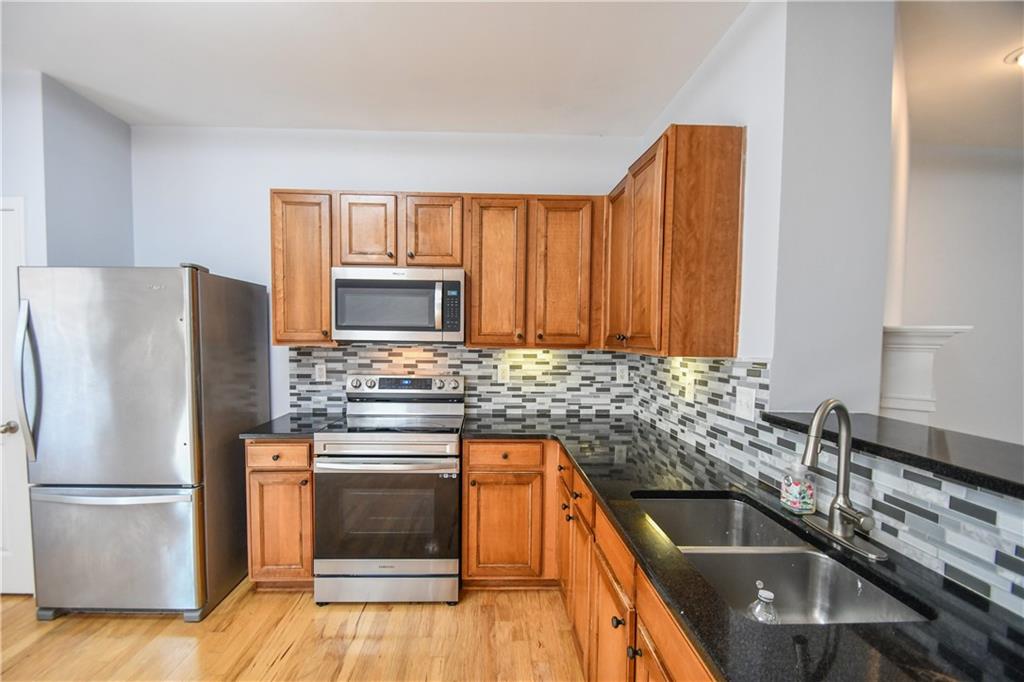 2201 Landing Walk Drive Duluth, GA 30097 - Photo 43 of 80 a kitchen with a sink stove and refrigerator