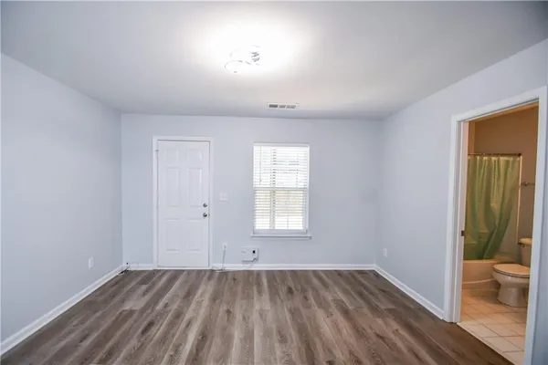 a view of wooden floor and windows in a room