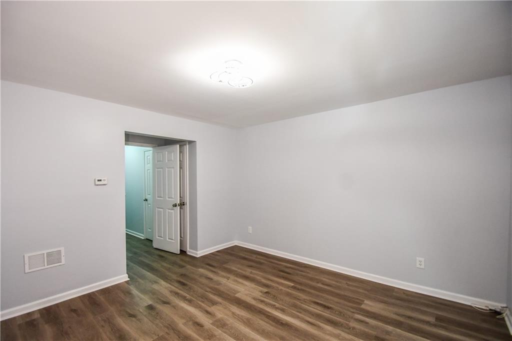 2201 Landing Walk Drive Duluth, GA 30097 - Photo 47 of 80 a view of an empty room with wooden floor and closet