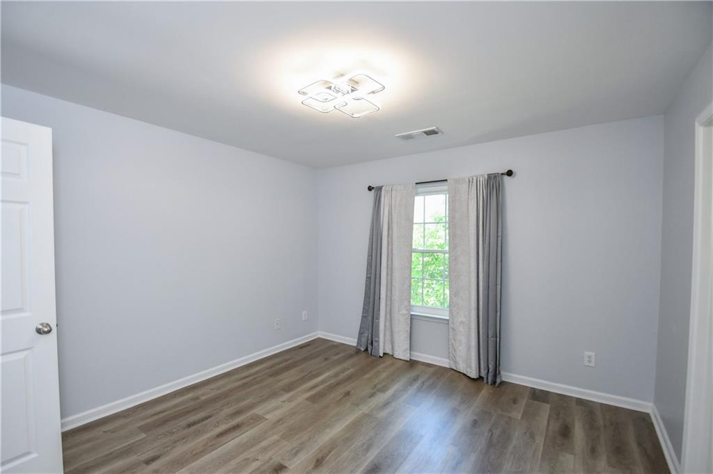 2201 Landing Walk Drive Duluth, GA 30097 - Photo 59 of 80 an empty room with wooden floor and windows