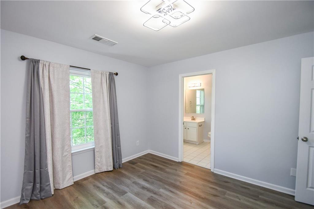 2201 Landing Walk Drive Duluth, GA 30097 - Photo 61 of 80 a view of an empty room with wooden floor and a window
