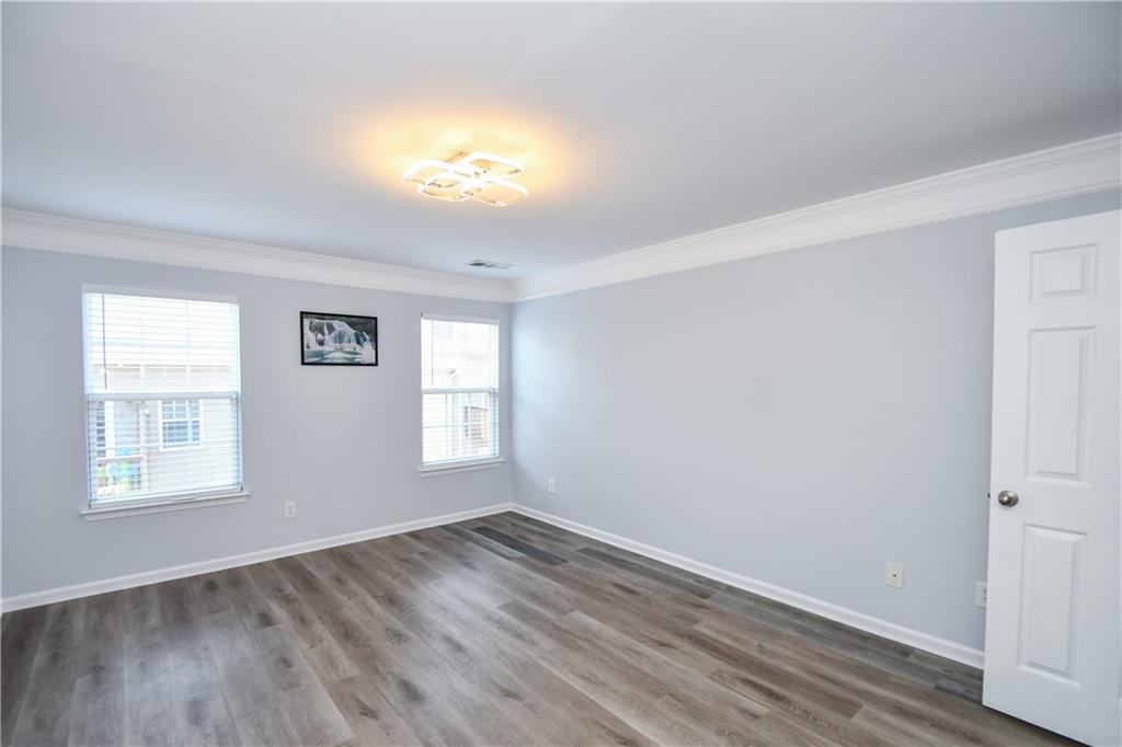 2201 Landing Walk Drive Duluth, GA 30097 - Photo 69 of 80 an empty room with wooden floor and windows