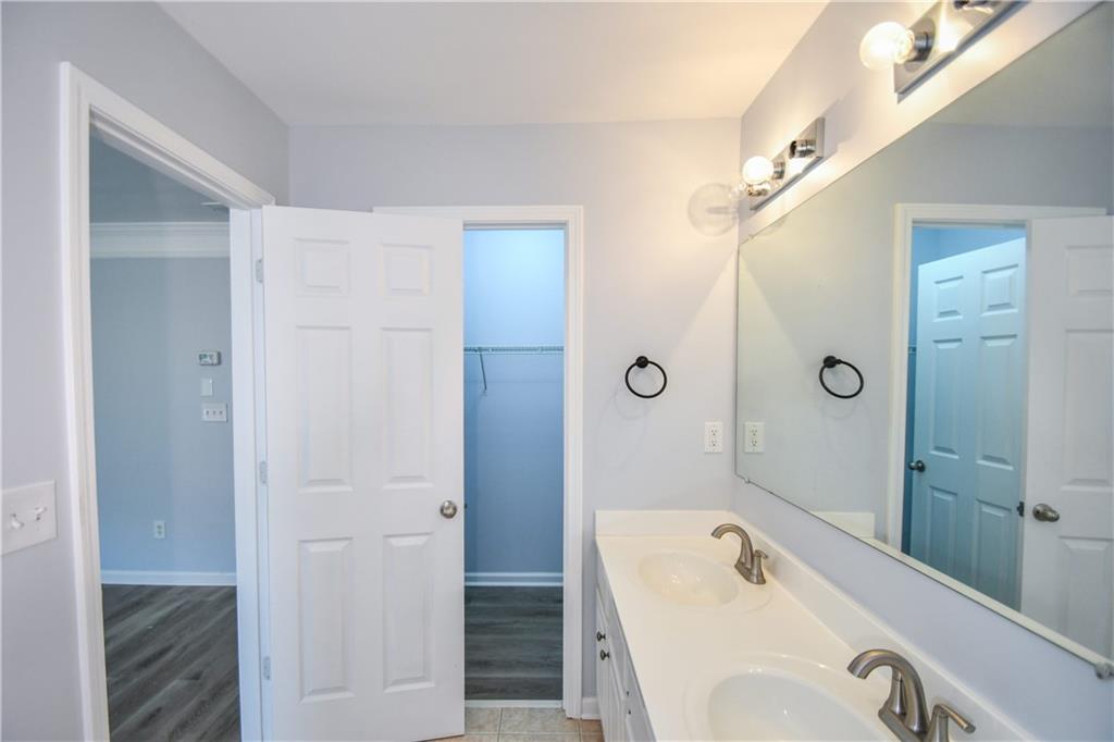2201 Landing Walk Drive Duluth, GA 30097 - Photo 76 of 80 a bathroom with a tub sink and mirror