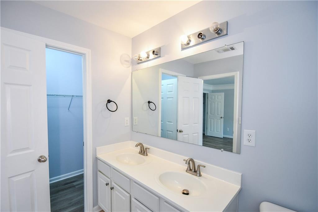2201 Landing Walk Drive Duluth, GA 30097 - Photo 77 of 80 a bathroom with a sink a toilet and shower
