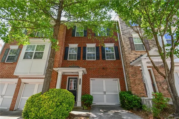 a view of empty room with wooden floor and fireplace