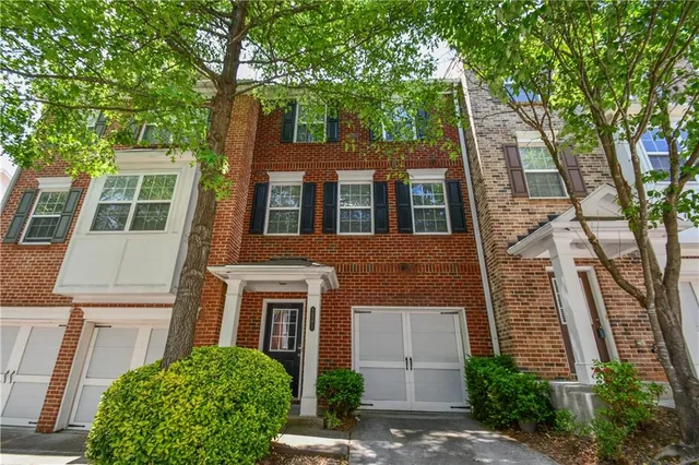 a view of empty room with wooden floor and fireplace