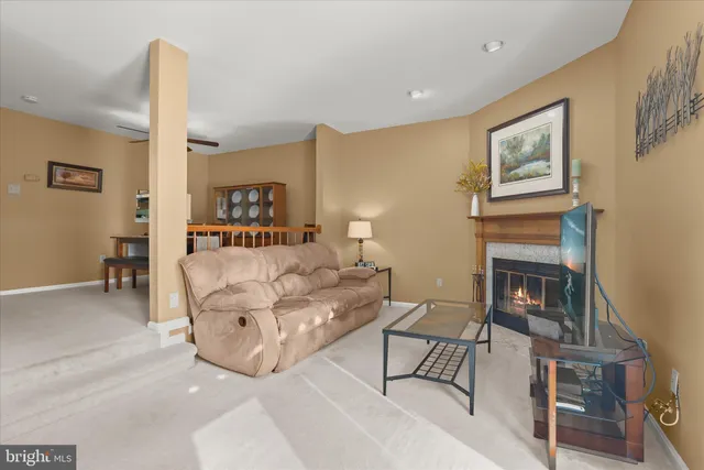 a living room with furniture and a lamp