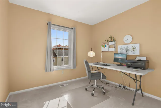 a living room with furniture a table and a potted plant