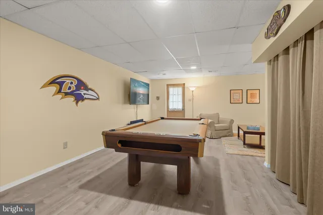 a room with pool table and windows