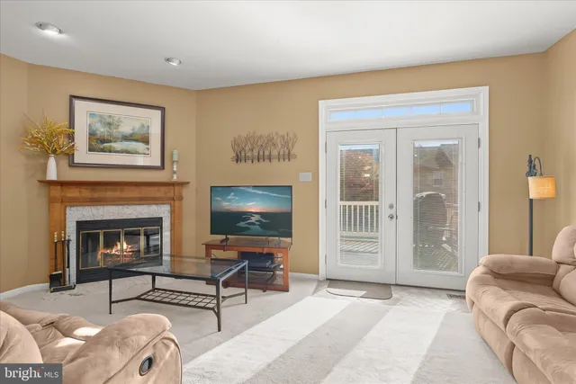 a living room with furniture a fireplace and wall paintings