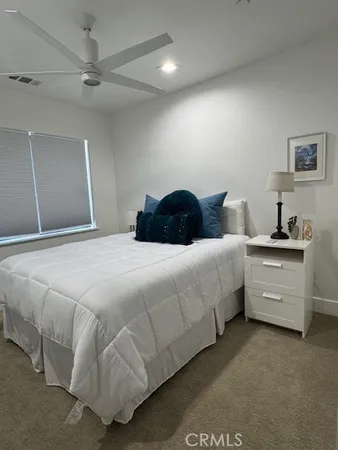 a bedroom with a bed and a night stand