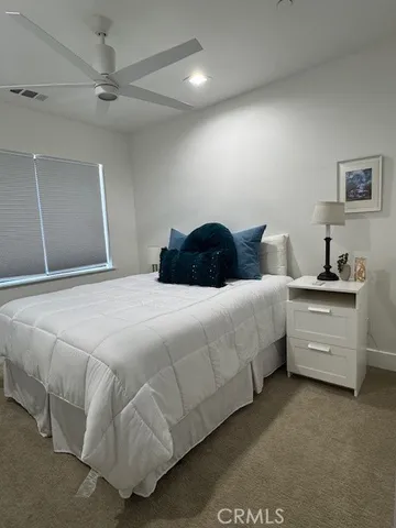 a bedroom with a bed and a night stand