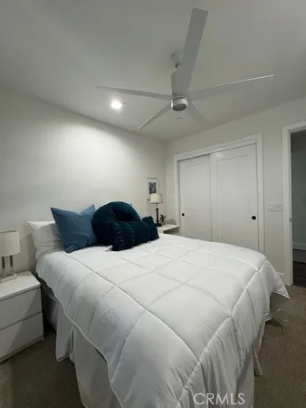 a large bedroom with a bed and a chandelier