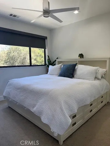 a bedroom with a bed and window