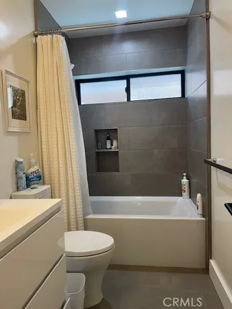 a bathroom with a sink a toilet and bathtub