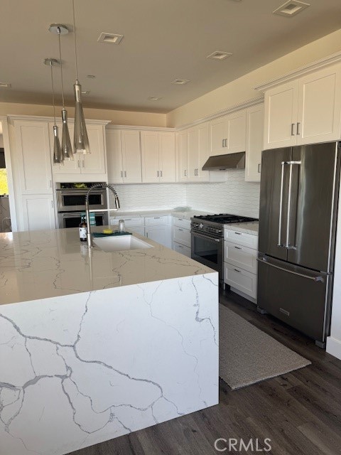 61 Birch Avenue Cayucos, CA 93430 - Photo 7 of 21 a kitchen with kitchen island a counter top space a sink stainless steel appliances and cabinets