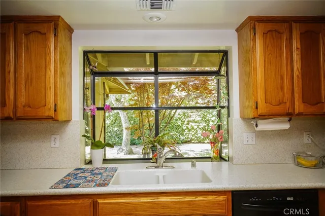 a kitchen with stainless steel appliances granite countertop a refrigerator and a stove