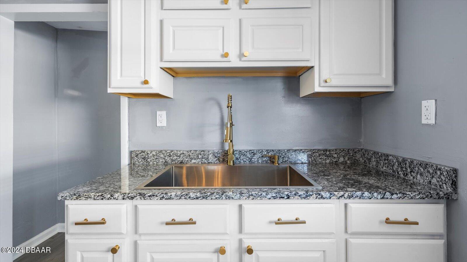 269 Selden Avenue Ormond Beach, FL 32174 - Photo 11 of 41 a kitchen with granite countertop a sink and cabinets