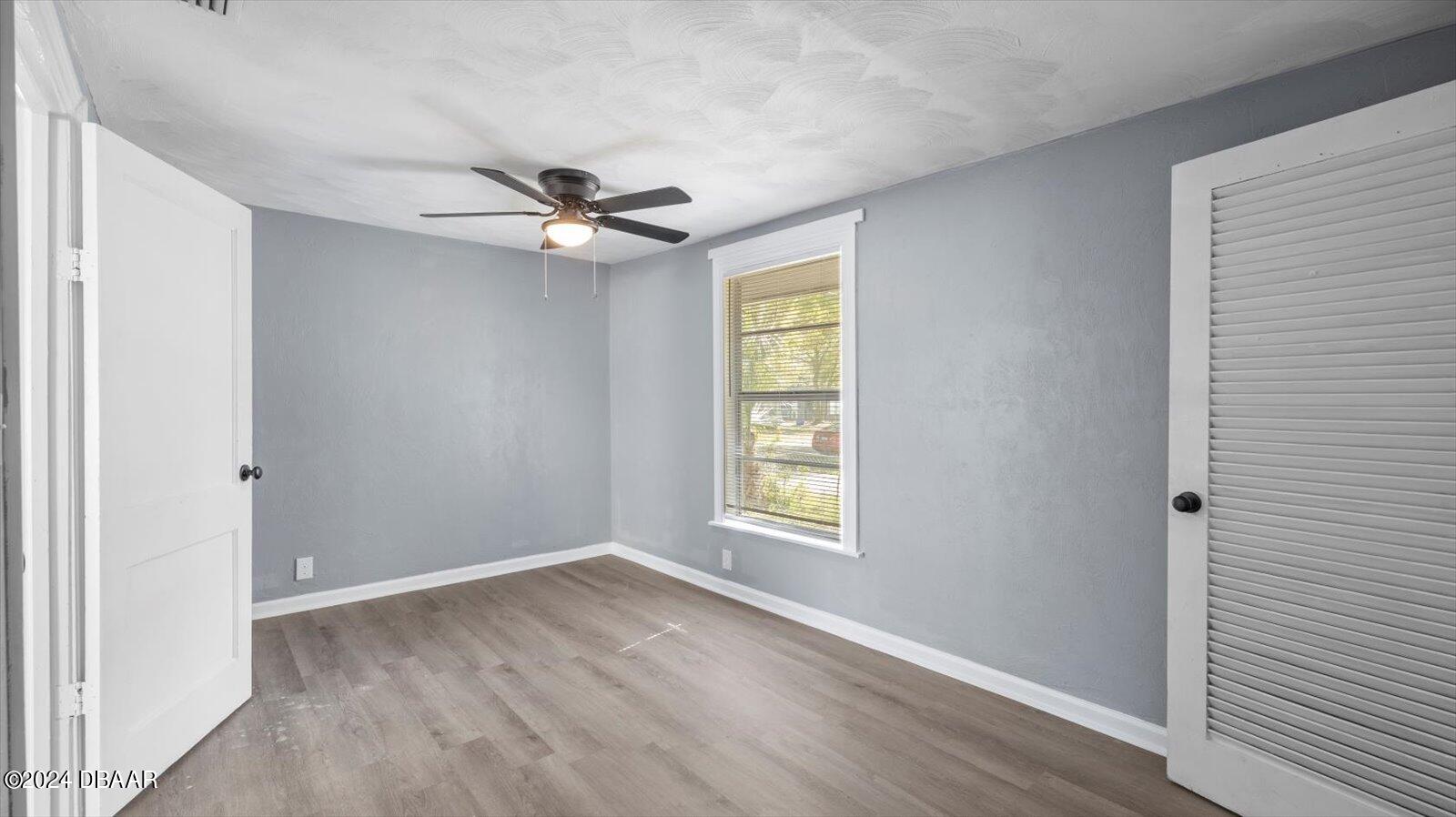 269 Selden Avenue Ormond Beach, FL 32174 - Photo 19 of 41 an empty room with windows and ceiling fan